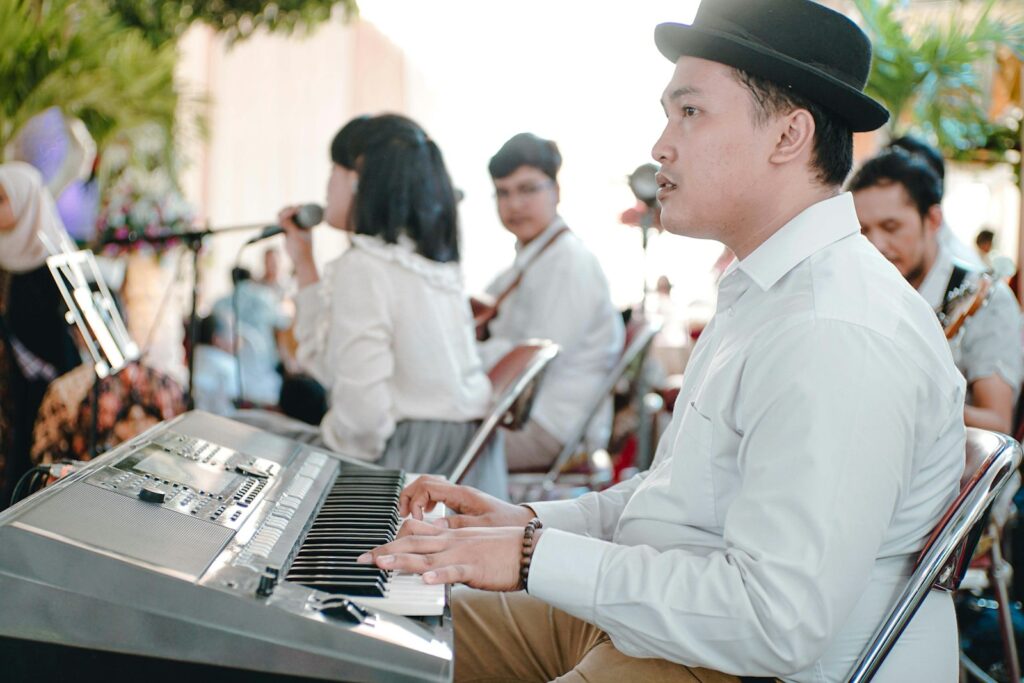 man in white dress shirt playing piano